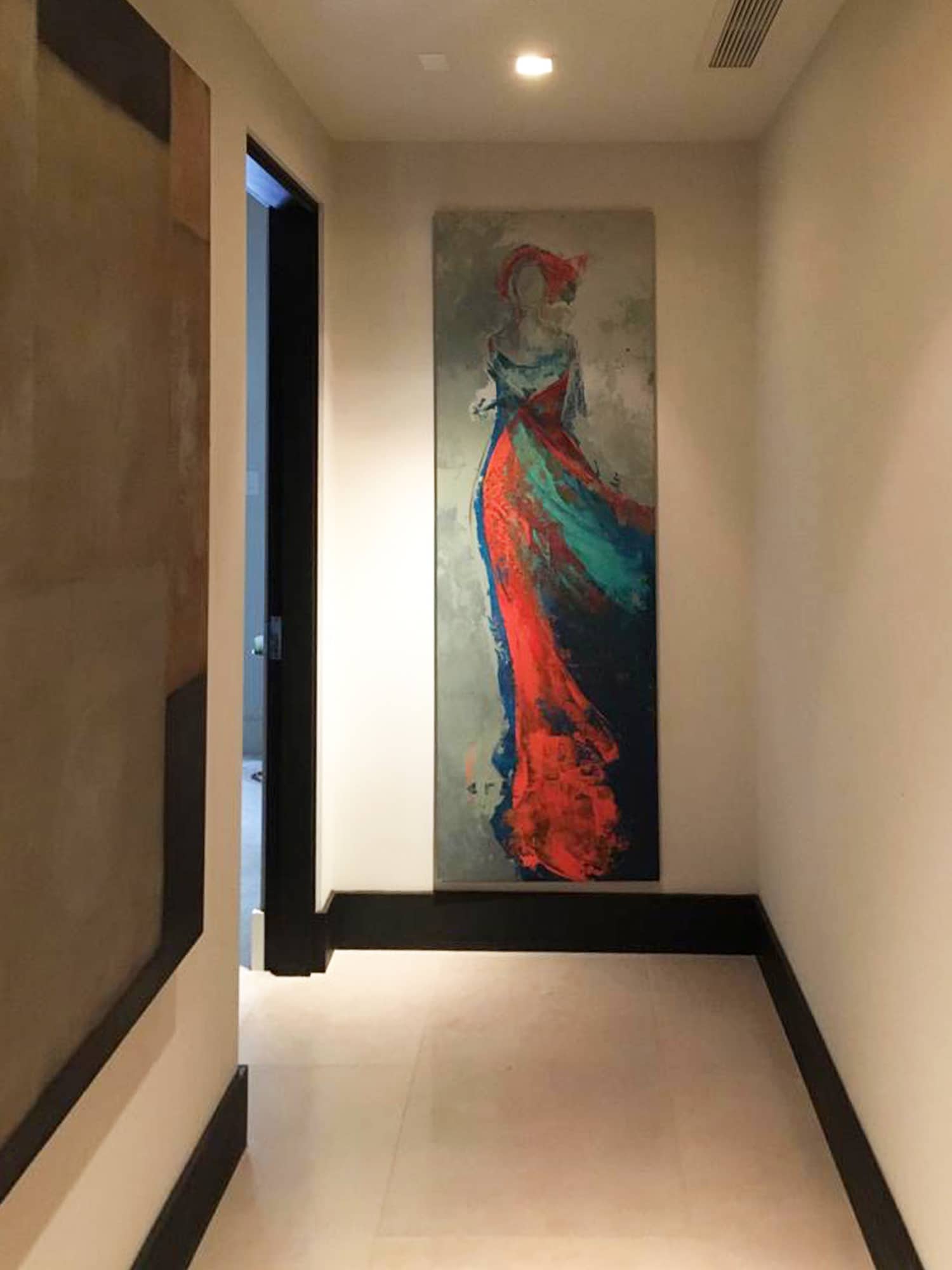 This boldly colored painting by Ana Gallart draws the eye down the hallway